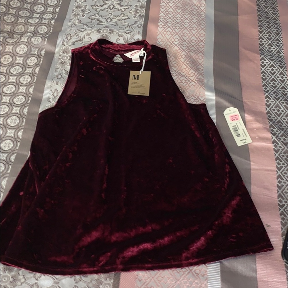 Burgundy sleeveless top.